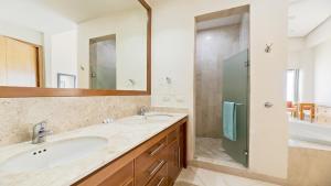 a bathroom with a sink and a shower at Luna Blanca Penthouse by Kivoya in Puerto Peñasco +27 photos