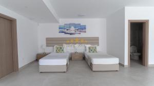 a bedroom with two beds and a toilet at Aretousa Ena by Prestige Bookings in Peyia