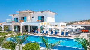 a villa with a swimming pool in front of a resort at Aretousa Ena by Prestige Bookings in Peyia +15 photos