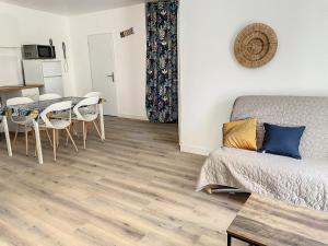 a living room with a couch and a table at Saint Camille in Sète