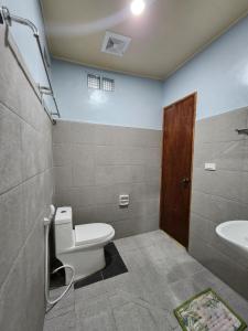 a bathroom with a toilet and a sink at MJ's Residences Garden Hotel in Moalboal +41 photos