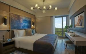 A bed or beds in a room at Somerset Maslak Istanbul