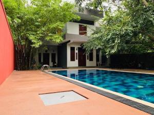 a swimming pool in front of a building at Villa Tambaka in Anuradhapura