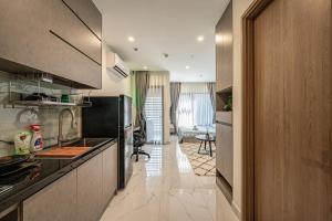 a kitchen with a counter top and a room at Linh Chi Homestay in Long Bình