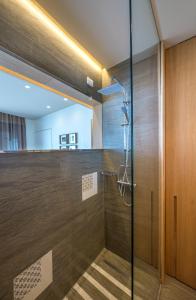 a shower in a room with a glass door at Gaura Apartments in Trapani
