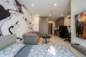 a bedroom with a bed and a living room at Linh Chi Homestay in Long Bình