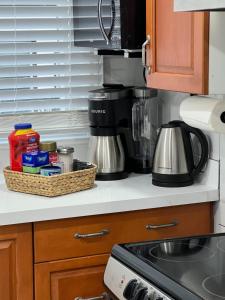 a kitchen counter with a coffee maker and a basket of food at Niagara Escape Loft in St. Catharines