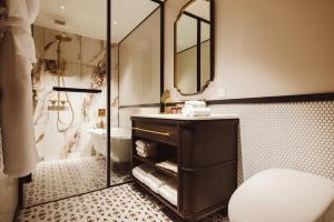 ein Badezimmer mit Waschbecken, Toilette und Dusche in der Unterkunft Mampei Hotel in Karuizawa