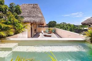 a villa with a swimming pool and a resort at Zambo in Tulum