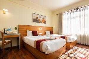 Uma cama ou camas num quarto em Magnificent Hotel