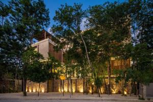 a building with lights on the side of it at Xielo in Tulum