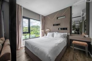 Mountain-view 1BR 9F Sriracha byน้องมังคุด NoParking客房内的一张或多张床位