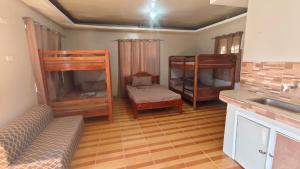 a living room with two bunk beds and a couch at Diva Sunrise beach resort in Dipaculao +25 photos