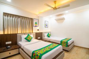 Voodi või voodid majutusasutuse Treebo Petals Banquet & Suites - Kolkata toas