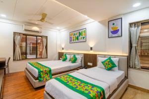 Voodi või voodid majutusasutuse Treebo Petals Banquet & Suites - Kolkata toas