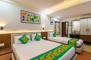 Postel nebo postele na pokoji v ubytování Treebo Petals Banquet & Suites - Kolkata + 29 fotografií