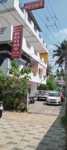 a building with cars parked in front of it at Tabish INN in Trivandrum