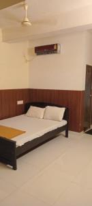 a bed in a room with avertisementatronatronstrationstrationstrationstration at Tabish INN in Trivandrum