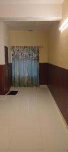 a empty room with a curtain and a room with white floors at Tabish INN in Trivandrum