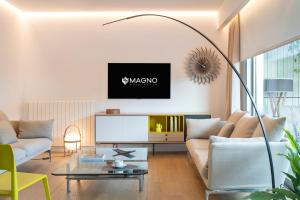 a living room with a couch and a tv at Magno Apartment Ramón Carande- Private Parking included in Seville