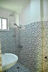 a bathroom with a shower and a sink at Dos Marias Tourist Inn in Daanbantayan +15 photos
