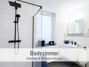 a bathroom with a shower with a glass door at Ferienwohnung Alte Schule Kennfus - Ruhe genießen in Bad Bertrich +19 photos