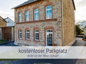 a brick house with the text kotszerker parkicismick your dear alien at Ferienwohnung Alte Schule Kennfus - Ruhe genießen in Bad Bertrich