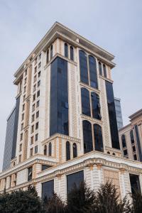 杜尚别Spacious and Premium 2 Bedroom Apartment with Panoramic Terrace and Rudaki Park View in Prime Dushanbe Location的有很多窗户的高楼