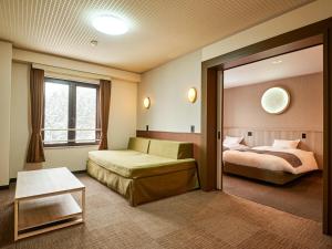 Ένα ή περισσότερα κρεβάτια σε δωμάτιο στο Hotel Abest Happo Aldea +130 φωτογραφίες