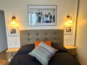 a couch in a living room with two lights and a picture at Joyau au cœur de la vieille ville de Bonifacio in Bonifacio