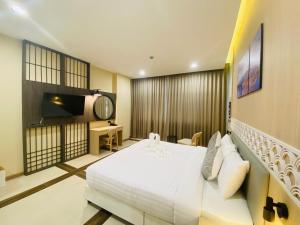 Postel nebo postele na pokoji v ubytování Asawann Hotel Suvarnabhumi