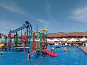 a group of people in the water at a water park at Pensiunea Casa Zanelor in Floreşti