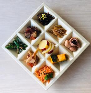 a white plate filled with different types of food at 養老温泉ゆせんの里ホテルなでしこ in Yoro