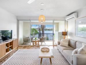 a living room with a couch and a tv at Goldsborough Place Apartments in Brisbane