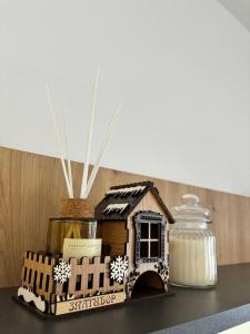 a gingerbread house on top of a table with a jar at Tanasković Home Zlatibor in Zlatibor
