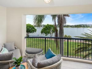 a balcony with chairs and a view of the water at Goldsborough Place Apartments in Brisbane