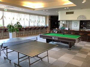 a room with two ping pong tables and a bar at 養老温泉ゆせんの里ホテルなでしこ in Yoro
