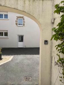 an entrance to a white building with a garage at La Flo in La Flocellière