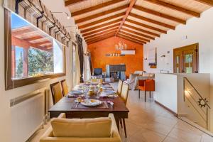 a dining room with a table and a kitchen at Nidri Hills Villa in Nydri