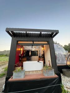 a black tent with potted plants in it at The Vino Dome By Once Upon a Dome Franschhoek in Franschhoek +38 photos