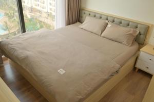 a bed in a room with a large window at Luxury I3 Imperia Smart City Hanoi - Free Gym - 30 percent off for one month up in Phú Thú