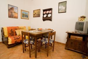 a living room with a table and a tv at Podere Il Fattoio in Figline Valdarno