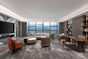 a living room with a couch and a table at Wyndham Garden Xunyang Downtown in Xunyang
