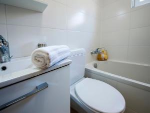 a bathroom with a toilet and a sink and a tub at Apartments AnaMar in Rovinj