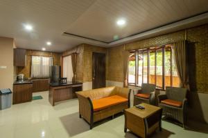 a living room with a couch and a table at Family Only Pool & Mountain View Modern Bamboo Villa - De Reiz Ethnic Syariah in Bandung