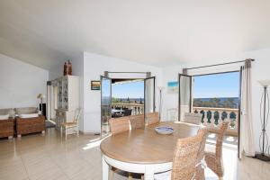 a living room with a wooden table and chairs at Jolie bastide 5 chambres avec belle vue mer in Mandelieu-la-Napoule
