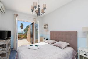 a bedroom with a bed with two pillows on it at Jolie bastide 5 chambres avec belle vue mer in Mandelieu-la-Napoule
