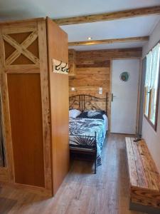 a bedroom with a bed and a wooden door at La pampa in Cabannes