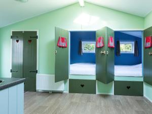 a room with two bunk beds and a kitchen at Nature Retreat for Groups in De Bult +31 photos