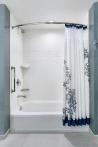 a bathroom with a tub and a shower curtain at Residence Inn by Marriott Lynchburg in Lynchburg +13 photos